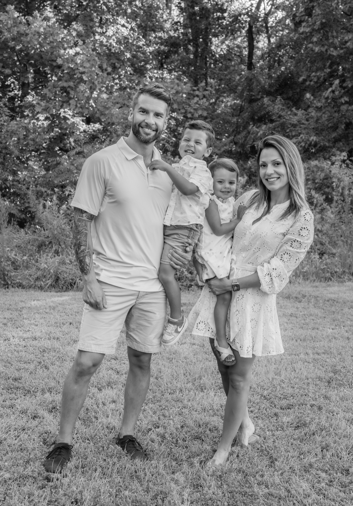 Stefan Friend with his wife and two young children — a joyful black and white family portrait